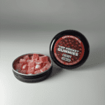 Earth Nectar Co. Top Pocket Gummies in Cherry, open tin of THC mini gummies beside the sealed tin