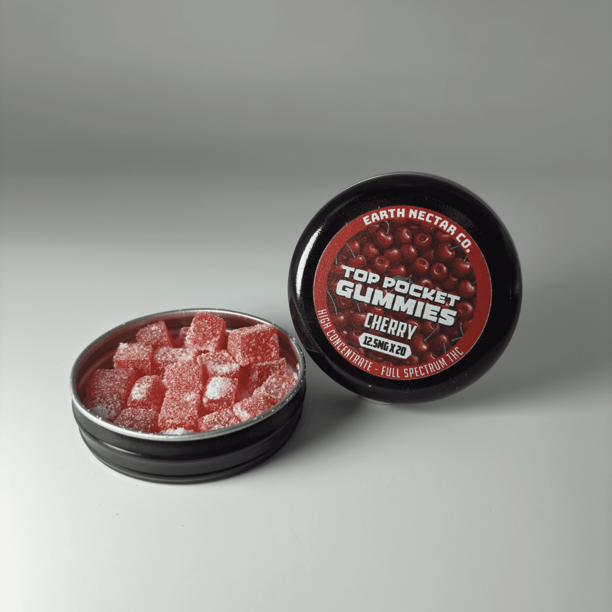 Earth Nectar Co. Top Pocket Gummies in Cherry, open tin of THC mini gummies beside the sealed tin