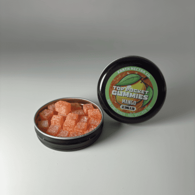 Earth Nectar Co. Top Pocket Gummies in Mango, open tin of THC mini gummies beside the sealed tin