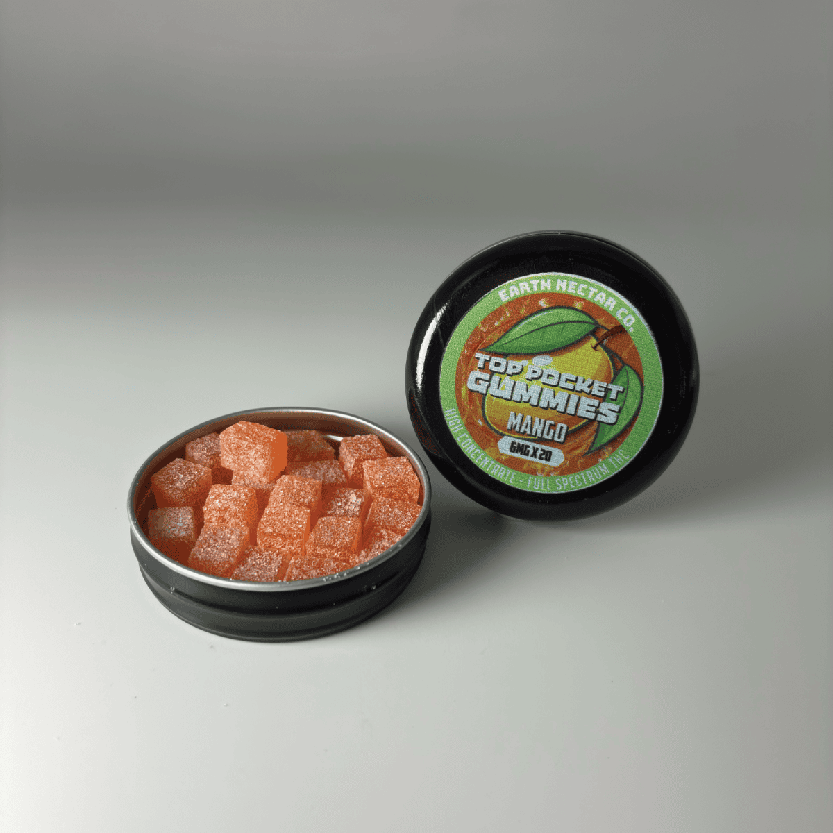 Earth Nectar Co. Top Pocket Gummies in Mango, THC mini gummies in an open pocket tin