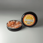 Earth Nectar Co. Top Pocket Gummies in Orange, open tin of THC mini gummies beside the sealed tin