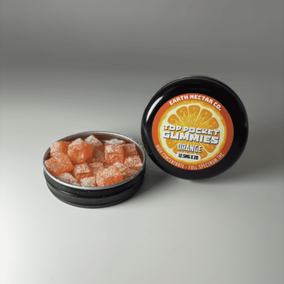 Earth Nectar Co. Top Pocket Gummies in Orange, open tin of THC mini gummies beside the sealed tin