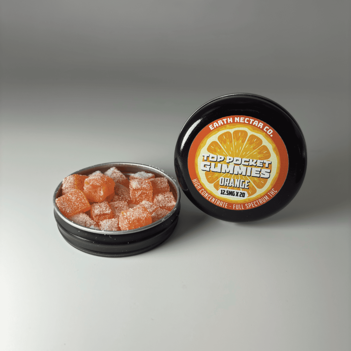 Earth Nectar Co. Top Pocket Gummies in Orange, open tin of THC mini gummies beside the sealed tin
