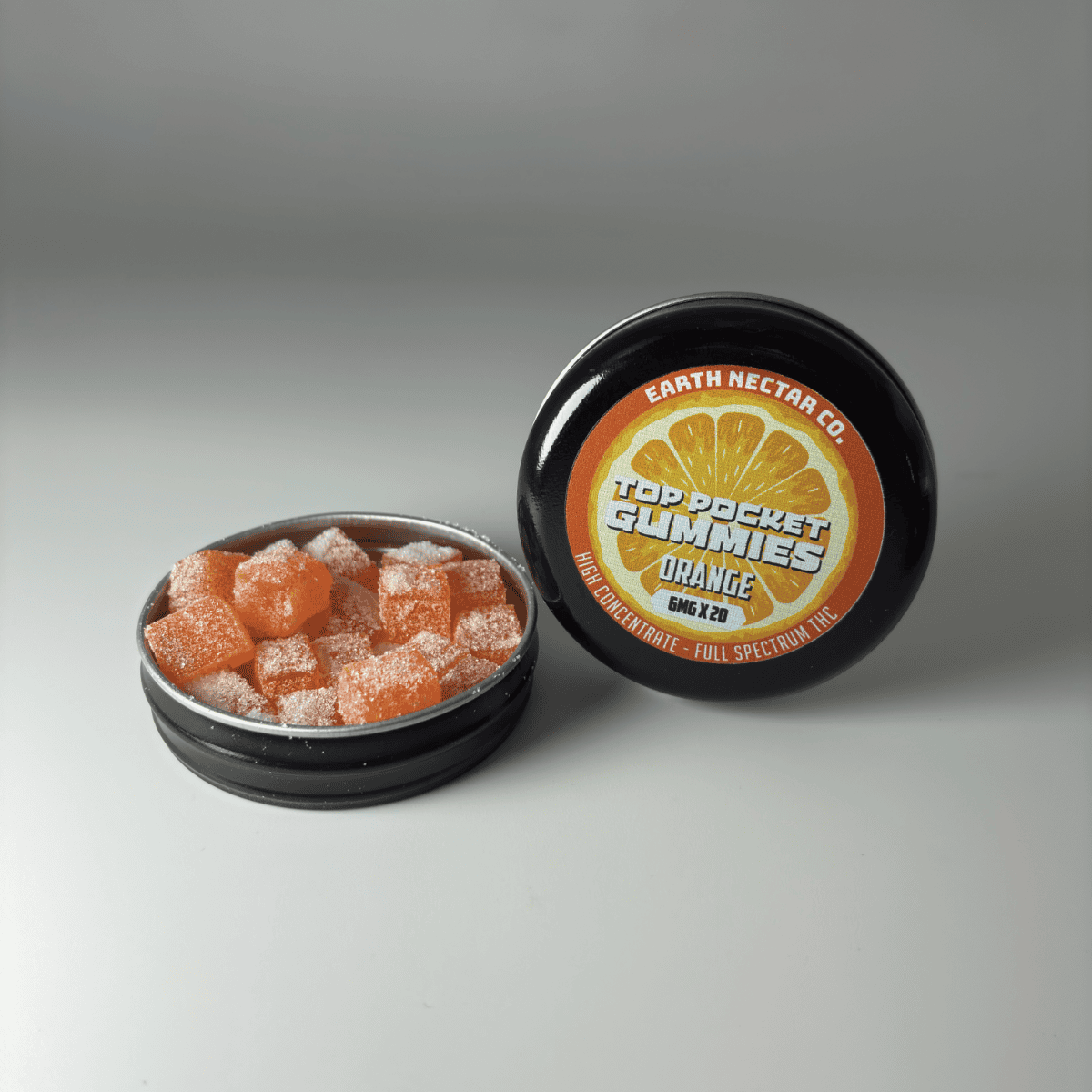 Earth Nectar Co. Top Pocket Gummies in Orange, THC mini gummies in an open pocket tin