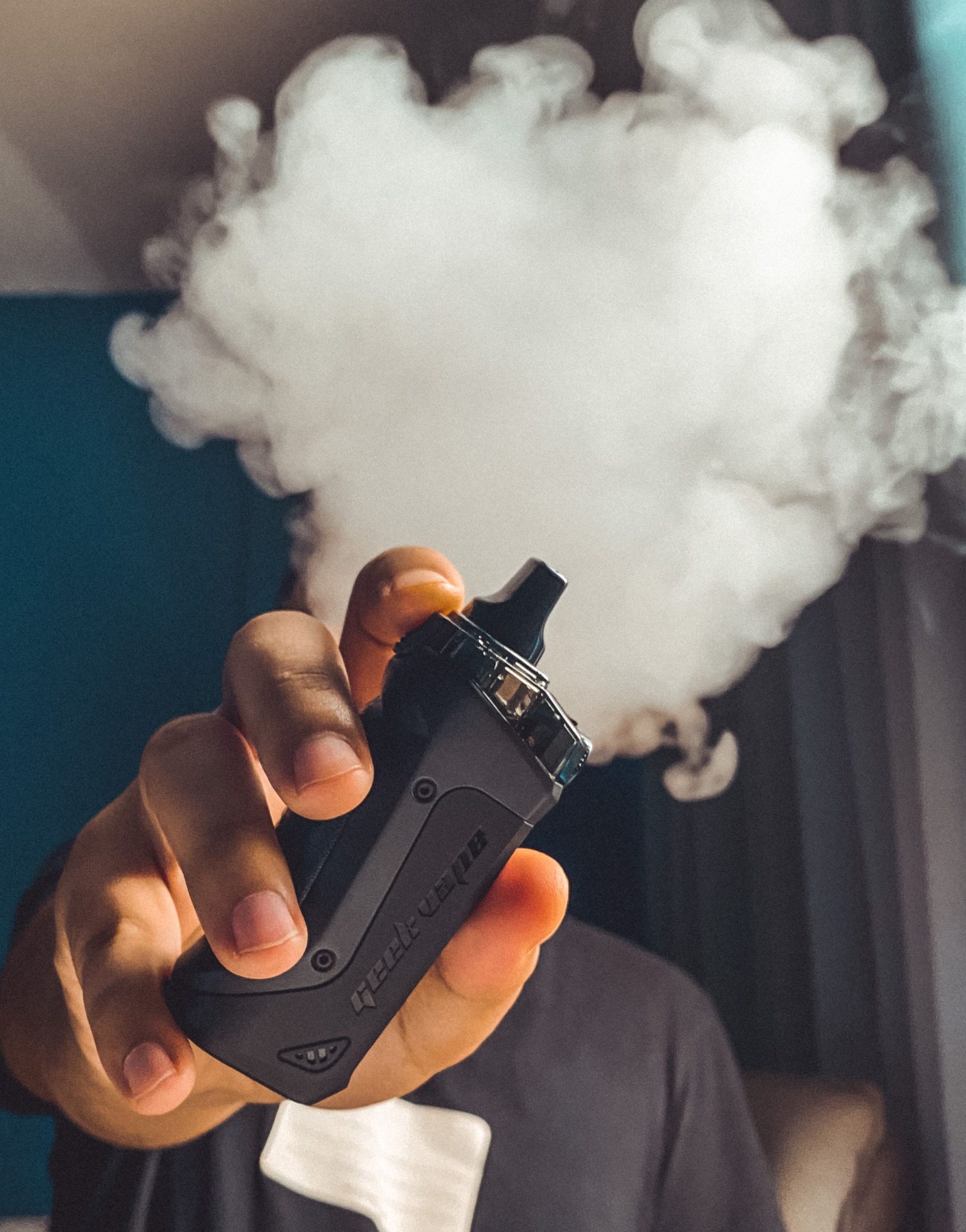 Vapour rising from a handheld vape device in use.